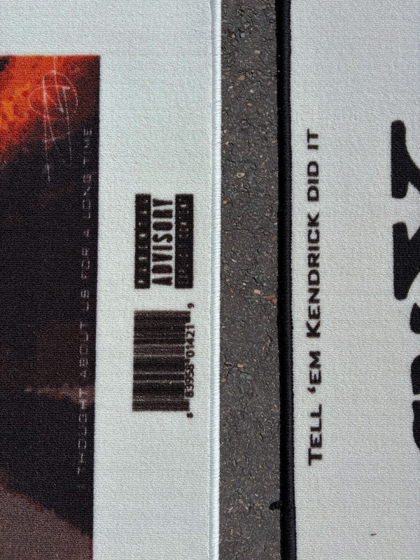 GNX × Blonde – barcode & advisory Close view of GNX and Blonde rugs side by side; Blonde barcode and Parental Advisory visible, GNX title prominent