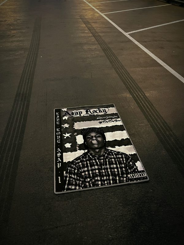 LIVE.LOVE.A$AP rug – parking lot shot LIVE.LOVE.A$AP rug on a concrete parking lot, partial view with tire skid marks for a gritty look